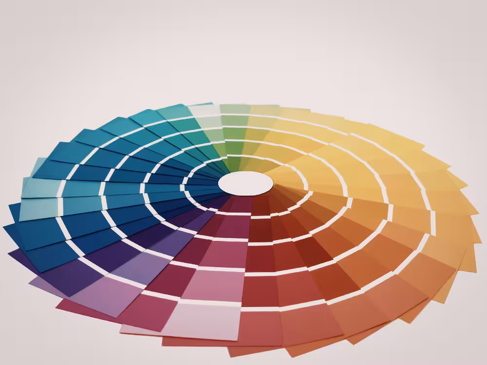 Roda de cores circular com gradiente completo de tons azul, verde, amarelo, laranja, vermelho, roxo e magenta, disposta em camadas concêntricas sobre fundo branco.